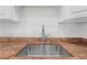 Close up on the stainless sink and faucet with tan countertops at 3051 S Atlantic Ave # 1003, Daytona Beach, FL 32118