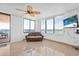 Relax in this living room featuring tile flooring, ceiling fan, balcony access, and floor to ceiling windows offering ocean views at 3051 S Atlantic Ave # 1003, Daytona Beach, FL 32118