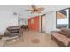 Living area with tile floors, leather furniture, dining area, and water view at 3051 S Atlantic Ave # 1003, Daytona Beach, FL 32118