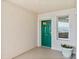 Balcony featuring a bright green door and a decorative potted plant at 3315 S Atlantic Ave # 1605, Daytona Beach Shores, FL 32118