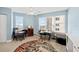 Bedroom with great light, a view, ceiling fan, colorful round rug, and blue accent wall at 3315 S Atlantic Ave # 1605, Daytona Beach Shores, FL 32118