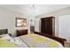 Bright bedroom featuring a queen bed, wood furniture, and ample closet space at 3315 S Atlantic Ave # 1605, Daytona Beach Shores, FL 32118
