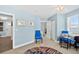 Bedroom with blue walls features a view, colorful round rug, and ensuite bathroom at 3315 S Atlantic Ave # 1605, Daytona Beach Shores, FL 32118