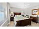 Bright bedroom featuring a wood bed frame, ceiling fan, and two side tables with lamps at 3315 S Atlantic Ave # 1605, Daytona Beach Shores, FL 32118
