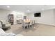 The community room features a long table, chairs, and bookshelves for reading and studying at 3315 S Atlantic Ave # 1605, Daytona Beach Shores, FL 32118