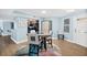 Cozy dining area with stylish round table, gray chairs, and modern decor leading to kitchen at 3315 S Atlantic Ave # 1605, Daytona Beach Shores, FL 32118