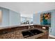 Modern kitchen sink area opens to living area with ocean view at 3315 S Atlantic Ave # 1605, Daytona Beach Shores, FL 32118