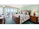 Bright main bedroom featuring a king bed, ocean view balcony, and comfortable furnishings at 3315 S Atlantic Ave # 1605, Daytona Beach Shores, FL 32118