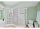 Modern shower with unique glass block surround and tile flooring in renovated bathroom at 3315 S Atlantic Ave # 1605, Daytona Beach Shores, FL 32118