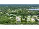 Expansive aerial view showcasing the neighborhood, highlighting the home's location near a lake and lush greenery at 3428 Saltee Cir, Ormond Beach, FL 32174