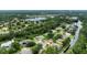 Scenic aerial view of a home nestled in a lush, green neighborhood with lake and creek views at 3428 Saltee Cir, Ormond Beach, FL 32174