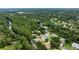 Aerial view showcasing the home's unique location nestled between a creek and lush greenery at 3428 Saltee Cir, Ormond Beach, FL 32174