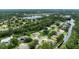 Aerial view of a lush residential area with a scenic lake surrounded by homes and beautiful natural landscape at 3428 Saltee Cir, Ormond Beach, FL 32174