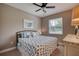 Comfortable bedroom with a full bed, ceiling fan, and bright, natural light at 3428 Saltee Cir, Ormond Beach, FL 32174