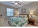 Comfortable bedroom with wicker bed, tropical comforter, ceiling fan and ample natural light at 3428 Saltee Cir, Ormond Beach, FL 32174