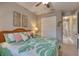 Comfortable bedroom featuring a tropical comforter, ceiling fan, closet and decorations at 3428 Saltee Cir, Ormond Beach, FL 32174