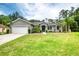 Inviting home with a well-kept lawn, lush landscaping, and attached two-car garage at 3428 Saltee Cir, Ormond Beach, FL 32174