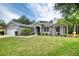 Charming single-story home featuring a well-manicured lawn and lovely landscaping at 3428 Saltee Cir, Ormond Beach, FL 32174