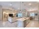 Open kitchen and living room with pendant lighting and vaulted ceilings at 3428 Saltee Cir, Ormond Beach, FL 32174