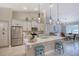 Bright kitchen features stainless appliances, pendant lights, and barstool seating at 3428 Saltee Cir, Ormond Beach, FL 32174