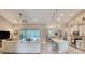 Open-concept kitchen and living room with modern lighting and outdoor access at 3428 Saltee Cir, Ormond Beach, FL 32174