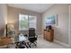 Home office with neutral paint, tile floors, and a large sunny window at 3428 Saltee Cir, Ormond Beach, FL 32174