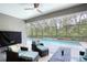 Comfortable covered patio with outdoor seating overlooking a pool and backyard scenery at 3428 Saltee Cir, Ormond Beach, FL 32174