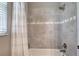 Modern shower featuring gray tiled walls and classic fixtures at 3428 Saltee Cir, Ormond Beach, FL 32174
