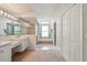 Sunlit bathroom featuring double vanity, shower, soaking tub, and closets at 3776 Sweet Grove Ct, Port Orange, FL 32129