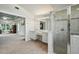 Bright bathroom featuring a double vanity and a glass-enclosed shower, adjoined to the carpeted main bedroom at 3776 Sweet Grove Ct, Port Orange, FL 32129