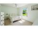 Bright bedroom features a ceiling fan, window with backyard view, and neutral carpet at 3776 Sweet Grove Ct, Port Orange, FL 32129