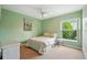 Bedroom featuring neutral carpeting, ceiling fan, and a window with tree views at 3776 Sweet Grove Ct, Port Orange, FL 32129