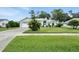 Inviting single-story home featuring lush landscaping and a well-maintained lawn at 3776 Sweet Grove Ct, Port Orange, FL 32129