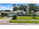 Lovely one-story home featuring manicured lawn and a two-car garage at 3776 Sweet Grove Ct, Port Orange, FL 32129