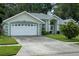 Charming single-story home with a two-car garage and a well-manicured lawn at 3776 Sweet Grove Ct, Port Orange, FL 32129