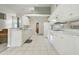 Well-lit kitchen featuring white cabinets, a breakfast bar, and modern appliances at 3776 Sweet Grove Ct, Port Orange, FL 32129