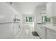 Clean, well-lit kitchen with white cabinetry, modern appliances, and tile flooring, offers a bright cooking space at 3776 Sweet Grove Ct, Port Orange, FL 32129