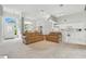Open-concept living area with neutral carpet, high ceilings, and abundant natural light at 3776 Sweet Grove Ct, Port Orange, FL 32129