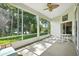 Enclosed porch with a ceiling fan and backyard views at 3776 Sweet Grove Ct, Port Orange, FL 32129