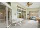 Relaxing sunroom with multiple sliding doors, a ceiling fan, and comfortable seating at 3776 Sweet Grove Ct, Port Orange, FL 32129