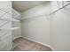 Spacious walk-in closet with metal shelving and neutral carpeting, offering ample storage at 3776 Sweet Grove Ct, Port Orange, FL 32129