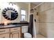 This bathroom features a shower, granite countertops, decorative mirror, and tile floor at 4204 Rocky Ridge Pl, Sanford, FL 32773