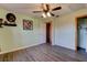 This bedroom has wood look floors, a ceiling fan, and a walk-in closet at 4204 Rocky Ridge Pl, Sanford, FL 32773