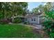 Charming single-story home with a well-maintained lawn, brick walkway, and mature trees providing ample shade at 4204 Rocky Ridge Pl, Sanford, FL 32773