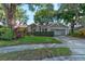 Inviting single-story home with mature landscaping, a red front door, and an attached two-car garage at 4204 Rocky Ridge Pl, Sanford, FL 32773