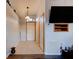 Hallway with neutral paint, tile floor, a pendant light, and coat closet at 4204 Rocky Ridge Pl, Sanford, FL 32773