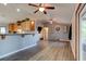 Open-concept living room with vaulted ceilings, hardwood floors, and kitchen breakfast bar at 4204 Rocky Ridge Pl, Sanford, FL 32773