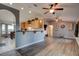 Open-concept living room with vaulted ceilings, ceiling fans, hardwood floors, and kitchen breakfast bar at 4204 Rocky Ridge Pl, Sanford, FL 32773