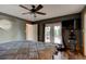 This is a bedroom featuring a ceiling fan, a wall mounted TV, and a door to the outside at 4204 Rocky Ridge Pl, Sanford, FL 32773