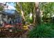 Serene screened porch overlooking a lush backyard with winding brick paths and mature trees creating a private oasis at 4204 Rocky Ridge Pl, Sanford, FL 32773